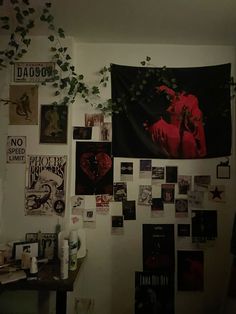 a wall covered in posters and plants