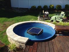 an above ground pool with a solar panel in the middle