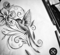 a drawing of a hummingbird with flowers and swirls on it's back