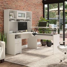 an office with brick wall and white furniture