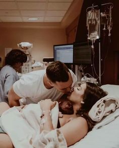 a man and woman kissing in a hospital bed