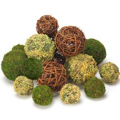 moss balls are arranged on top of each other in a pile, with one ball surrounded by the smaller ones