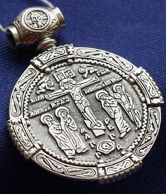 an antique silver pendant with the image of jesus on it