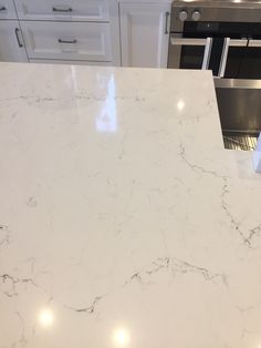 a white marble counter top in a kitchen