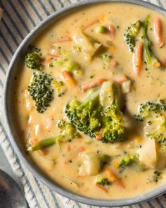 a bowl filled with broccoli and cheese soup