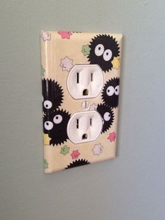 a light switch cover with black and white monsters on it