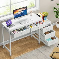 a computer desk with two drawers and a laptop on it, in front of a window