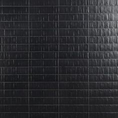 a black tile wall with white lines on it