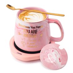 a pink coffee mug sitting on top of a saucer