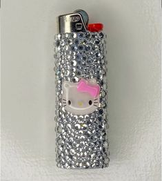 a hello kitty cell phone case with silver sequins and pink bow on it