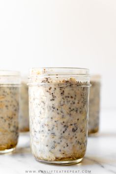 three jars filled with food sitting on top of a white counter next to each other