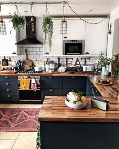 a kitchen filled with lots of counter top space next to a stove top oven and microwave