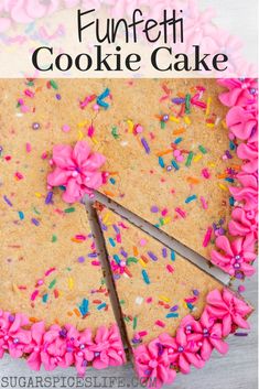 a cake with pink frosting and sprinkles is cut into pieces to make it