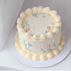 there is a white cake with flowers on it