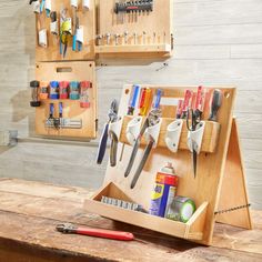 a wooden workbench with many tools in it and hanging on the wall behind it