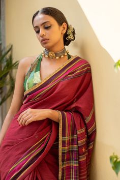 Burgundy saree with gold woven buttis all over in striped pattern and kiran lace border. Comes with running blouse piece.
Components: 1
Pattern: Woven
Type Of Work: Stripe
Fabric: Organic Cotton
Color: Red
Other Details: 
Kiran lace border
Note: Stitched blouse worn by the model is not for sale
Disclaimer: The joint fabric pieces may vary. Designers unique process ensures that the placement of fabric will always be similar but not same. They always create the product with stretch fabrics of simi Unstitched Banarasi Silk Blouse For Rituals, Unstitched Blouse For Diwali Rituals, Diwali Rituals Unstitched Blouse, Designer Red Paithani Silk Pre-draped Saree, Pre-draped Cutdana Saree For Rituals, Festive Anarkali Blouse For Rituals, Navratri Rituals Blouse With Zari Work, Transitional Cotton Silk Traditional Wear For Rituals, Festive Zari Work Blouse Piece For Rituals