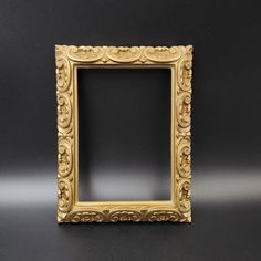 an ornate gold frame on a black background