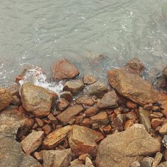 some rocks and water near the shore