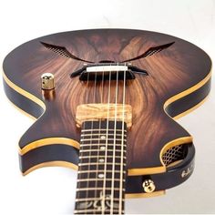 a close up of a guitar with a dragon on it's neck