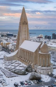 an aerial view of a large cathedral in the middle of a snow covered parking lot