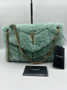 Stunning!!! YSL Yves Saint Laurent Small Shearling Lou Puffer Bag in Iced Mint!!! YSL Yves Saint Laurent Small size Lou Puffer Bag, Shoulder Bag, Crossbody in Iced Mint. Authentic. Super rare color nowadays! Comes with original dust bag, tags, authenticity cards and a gift receipt. Beautiful YSL handbag with gold logo on iced mint shearling with gold hardware. The bag measures 12” L x 7” H x 4” D Strap: 17” Made in Italy! Retail: over $3600 with tax Limited Edition piece! Ysl is not making shear Shearling Bags, Ysl Loulou Bag, Ysl Handbag, Ysl Handbags, Puffer Bag, Fluffy Bag, Sling Bag Black, Limited Edition Bag, Saint Laurent Handbags