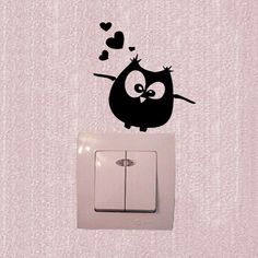 an owl is sitting on top of a wall light switch plate with hearts coming out of it