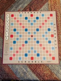 a scrabble board sitting on top of a rug