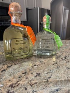 two bottles of happy birthday cologne sitting on a counter top next to eachother