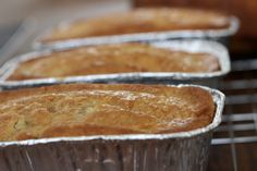 three muffins sitting on top of a metal rack next to another muffin