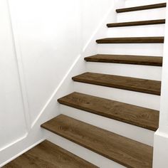 a set of wooden stairs with white walls