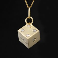 Why a dice, you ask? Well, we love die charms and pendants because they symbolize luck, chance, and risk-taking. Wearing dice-themed jewelry is often seen as a talisman or a way to attract good fortune and positive outcomes. This one has a nice, hefty feel to it, and with twinkling old cut diamonds all around! Perfect on both a charm bracelet or as a pendant. 14kt yellow gold Measures 1 cm 8.1 grams Diamonds are estimated to be G/H colors & VVS/SI1 clarities. GIA standards Please see qualitative Gift Jewelry: Square Pendant With Single Cut Diamonds, Symbolic Diamond Charms Jewelry, Gift Jewelry With Square Pendant And Single Cut Diamonds, Gift Jewelry With Single Cut Diamonds Square Pendant, Square Pendant Jewelry With Single Cut Diamonds For Gift, Luxury Diamond Charms For Gifts, Luxury Nugget-shaped Jewelry For Gifts, Luxury Nugget-shaped Jewelry Gift, Diamond Charms With Diamond Accents For Gifts