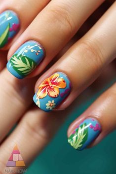 Hibiscus Floral Nail Art - These cool summer nails showcase beautiful hibiscus flowers against a blue backdrop, perfect for a fresh and lively summer look. For more summer nail designs, visit nailhow.com. Tropical Nails