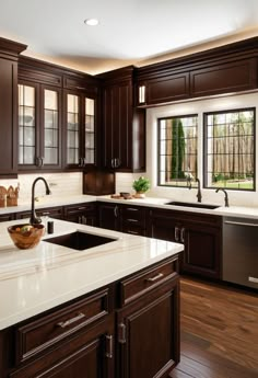 a kitchen with dark wood cabinets and white counter tops, along with a dishwasher