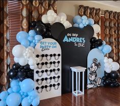 a mickey mouse party with balloons and decorations