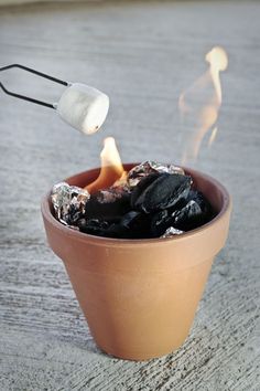 a bowl filled with coal next to a cracker