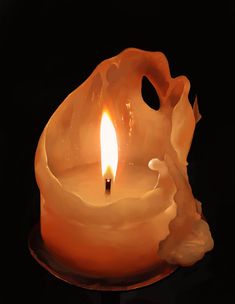 an orange candle with a black background