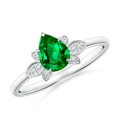 an emerald and diamond ring with leaves on the band, set in white gold setting