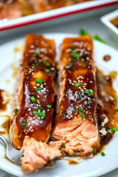 salmon with sesame seeds and sauce on a plate