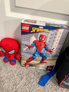 there is a spiderman toy next to a bag on the floor in front of a door