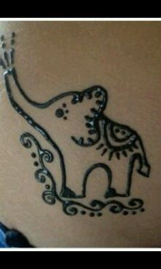 an elephant tattoo on the side of a woman's stomach