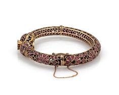 "This is a gorgeous vintage bangle bracelet, it is crafted from 9k rose gold featuring a double snake head joined at the front with a large round ruby mounted in a floral pot above the snakes head. The 9mm wide filigree tube bangle has fany open floral design set with a total of 6 carats rubies! It is hinged and secures with a push in clasp, chain is attached for added security. Material: 9k rose gold Ruby: 6.00 total carat weight Measurements: inner circumference: 6.75\" x 0.36\" wide x 0.32\" Antique Rose Gold Bracelets For Formal Occasions, Traditional Rose Gold Bracelet Jewelry, Traditional Rose Gold Bracelet, Elegant Ruby Bracelets For Ceremonial Occasions, Victorian Rose Gold Bracelets As Gift, Victorian Rose Gold Bracelets Gift, Traditional Rose Gold Bangle Bracelets, Traditional Rose Gold Bangle Bracelet, Antique Rose Gold Ruby Jewelry