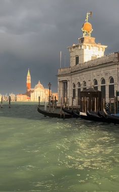 several gondolas are tied to the side of a pier in venice, italy