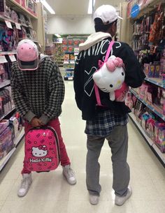 two people with hello kitty backpacks in a store