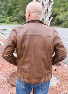 Exclusive Jamin Leather® Original distressed men's brown leather jacket with ribbed shoulders, waist and sleeves. Made of a super soft lambskin leather that is hand rubbed for a unique vintage well loved look. This uniquely styled leather jacket has a zip thru butterfly collar also comes with three front zippered front pockets, three inside pockets (one is a CC vertical pocket with barrel loop inside), antiqued brass hardware, adjustable snap cuffs, side zippers for sitting comfort, and super soft and comfortable satin lining. A unique updated style jacket for everyday use. Sizes: M, L, XL, 2X, 3X, 4X. +$10 for 2X-3X, +$20 for 4X. [6#] unique hand rubbed finish quilting ribbed shoulders, sleeves and waistband side zippers for sitting comfort zip through butterfly collar 3 front zippered fr Rugged Biker Jacket With Double-needle Long Sleeves, Trim Jacket, Brown Leather Jacket, Lambskin Leather, Brass Hardware, Unique Vintage, Brown Leather, Barrel, Quilting