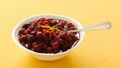 a white bowl filled with cranberry sauce on top of a yellow table