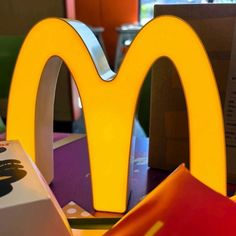 a mcdonald's sign sitting on top of a table next to some boxes and other items