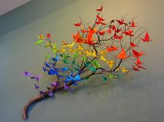 a tree with colorful origami birds on it