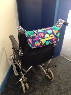 a small child's wheel chair sitting on the floor next to a blue door