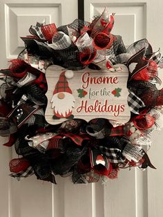 a christmas wreath with the words gnome for the holidays hanging on a white front door