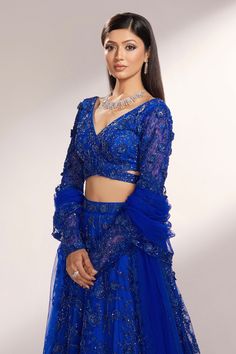 Royal blue net lehenga with attached can-can, all over tonal cut dana and 3D flower embroidery. Paired with V neck padded blouse with all over embroidery and dupatta with cut work hem.
Components: 3
Pattern: Embroidered
Type Of Work: 3D Flowers and Cut Dana Work
Neckline: V Neck
Sleeve Type: Full Sleeves
Fabric: Net
Color: Blue
Other Details: 
Cut work waist
Cut work back
Embroidered bordered dupatta
Attached lining
Weight Approx (in kgs): 5 - 6
Closure:
Lehenga: Side concealed zip, hook and eye Blue Organza Party Wear Choli, Blue Party Wear Sets With Intricate Embroidery, Blue Party Wear Sets With Unstitched Blouse, Blue Bollywood Organza Sets, Blue Party Wear Sets For Festive Occasions, Blue Semi-stitched Party Wear Sets, Blue Organza Anarkali Set For Party, Blue Party Wear Lehenga With Dori Work, Semi-stitched Royal Blue Sets For Party